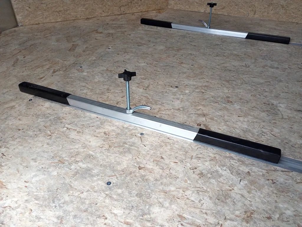 2024 Mission Trailers 12 ft Powersports – Side X Side – Metal tie down bars with adjustable knobs installed on the wood composite floor