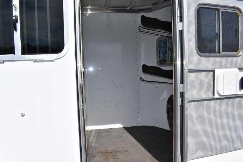 2005 Featherlite 2HST Horse Trailer – Walk-Through Dressing Room – Front tack room area with saddle racks visible through the door
