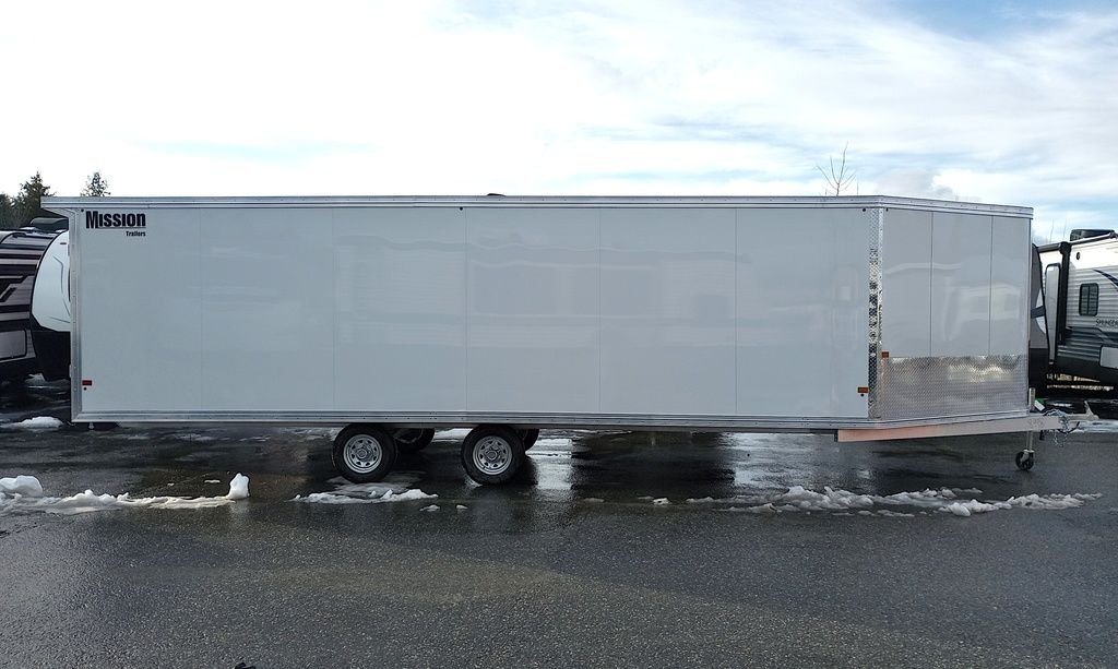 2024 Mission Trailers 24 ft Deckover – Galvanized Package – Direct side profile showing the full length of the white enclosed trailer