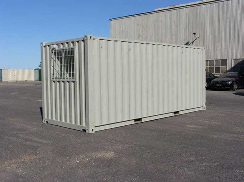 20 ft Container Change Room – Gray – Exterior three-quarter view of a beige portable container cabin with a barred window