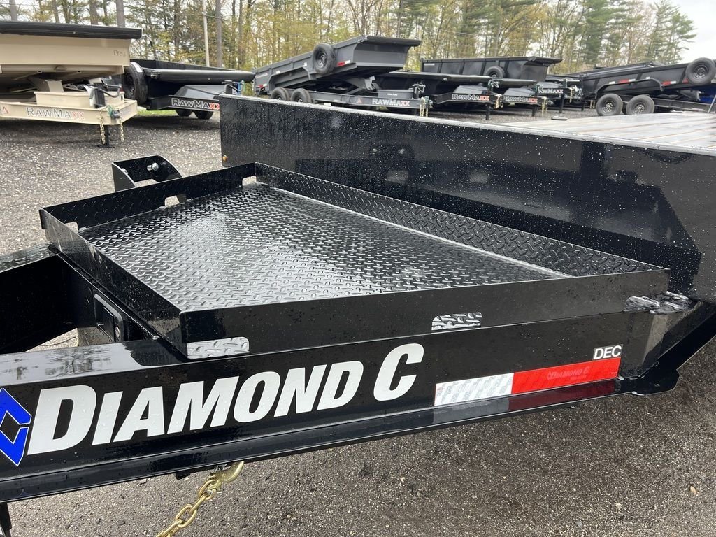 2024 Diamond C 24 ft Deckover – Blackwood Deck – Metal storage tray mounted on the tongue of the black trailer
