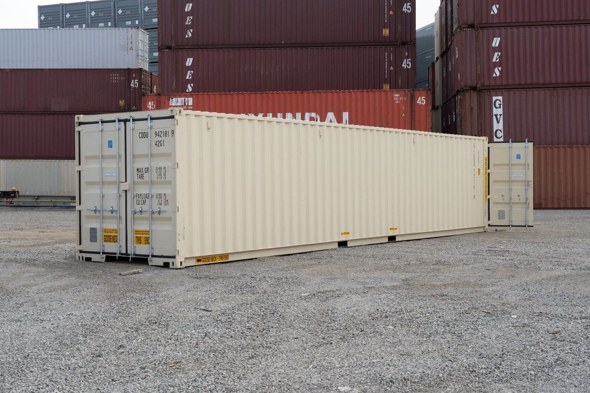40ft New Shipping Container – Double-End Cargo Doors – Three-quarter exterior of cream container with far-end door open