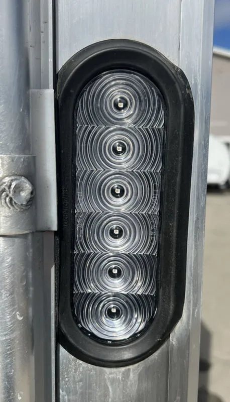 2023 High Country 14 ft Trailer – Blue, Drive-Through – Close-up of a clear vertical LED tail light mounted on the trailer frame