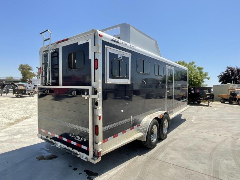 2005 Jamco 4 Horse Gooseneck Trailer – Blue, Air Suspension – Rear view from the driver side showing the ladder and back gate