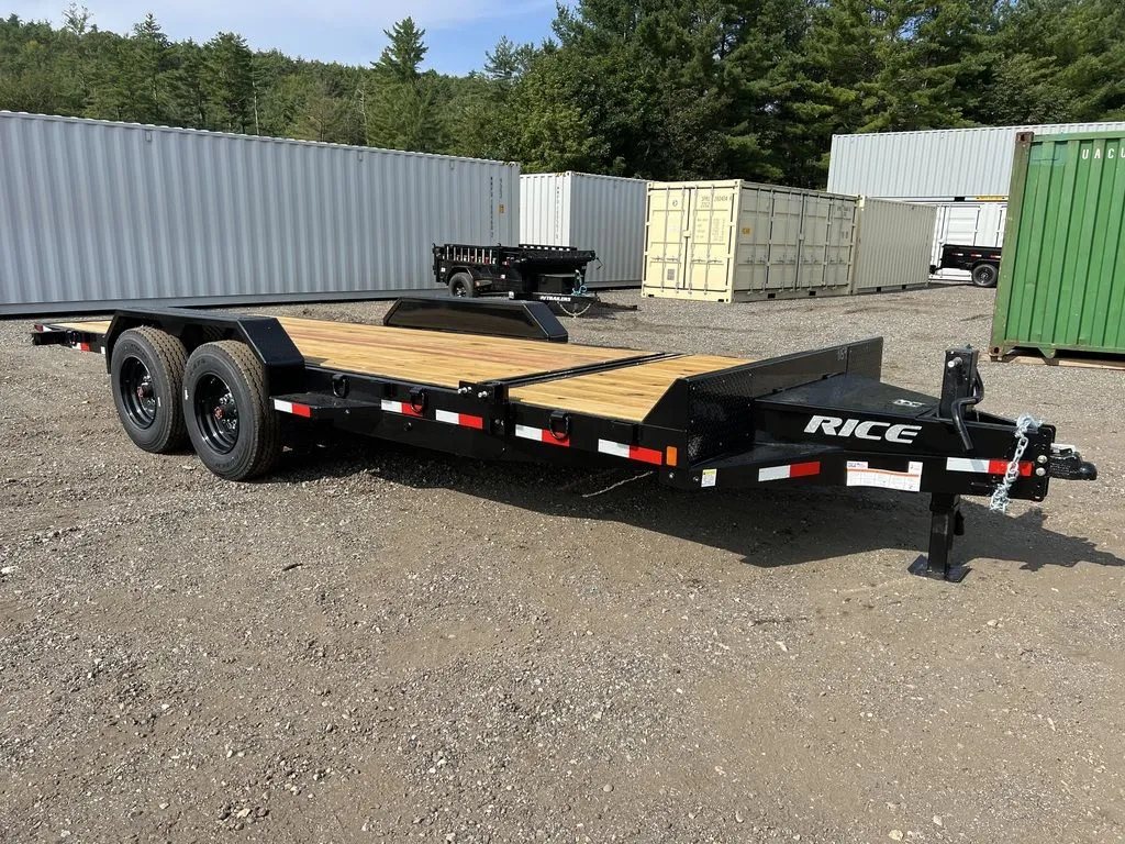 2024 Rice Trailers 20 ft Tilt Deck – Spare Mount – Clean three-quarter front view of a black flatbed trailer with wood deck