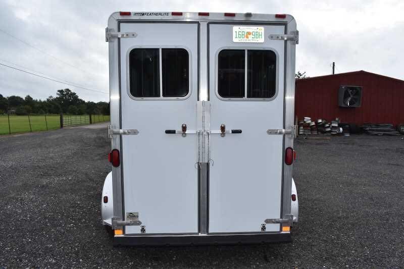 2003 Featherlite 2HST 2 Horse Trailer – Aluminum – Rear view of closed white double doors with windows and a license plate
