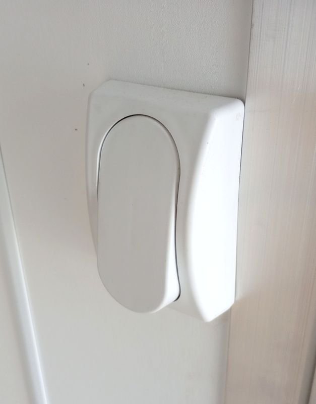 2024 Mission Trailers 24 ft Deckover – Galvanized Package – Close-up of a white plastic light switch mounted on the interior wall