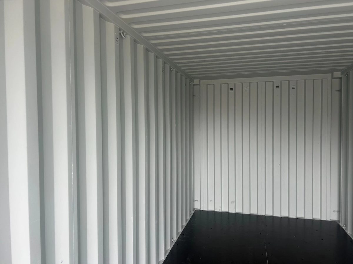 20ft New Shipping Container – One-Trip, Double Doors – empty container interior with pale corrugated walls and dark floor