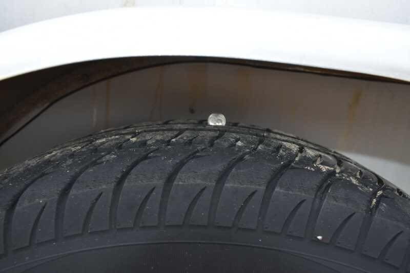 2001 CM Odyssey 2 Horse Trailer – Aluminum Floor – A close-up shot of a trailer tire tread under the wheel well