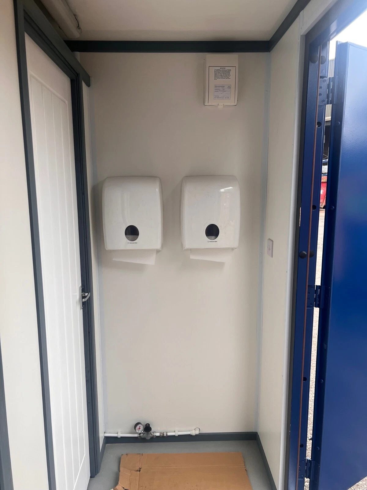 20ft Refurbished Container Toilet Block – Separate Compartments – toilet block entrance with two wall-mounted paper dispensers