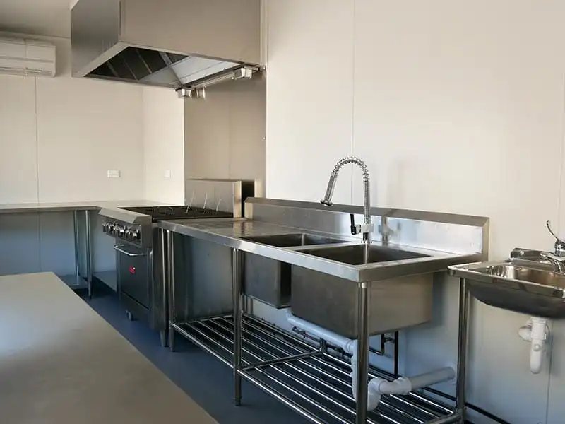 Shipping Container Kitchen – Insulated, Lockable – Professional kitchen setup with stainless steel double sinks and industrial stove