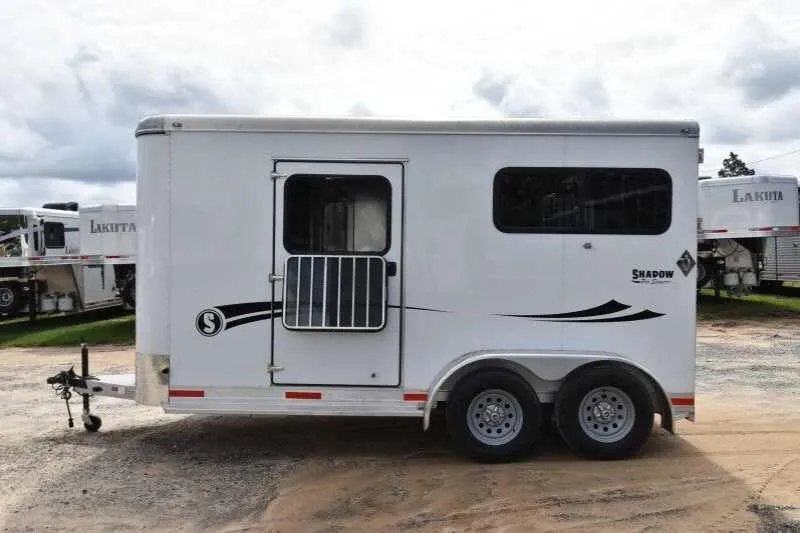 2016 Shadow 2 Horse Trailer – Aluminum, Dressing Room – Left side exterior profile of the white horse trailer against a cloudy sky