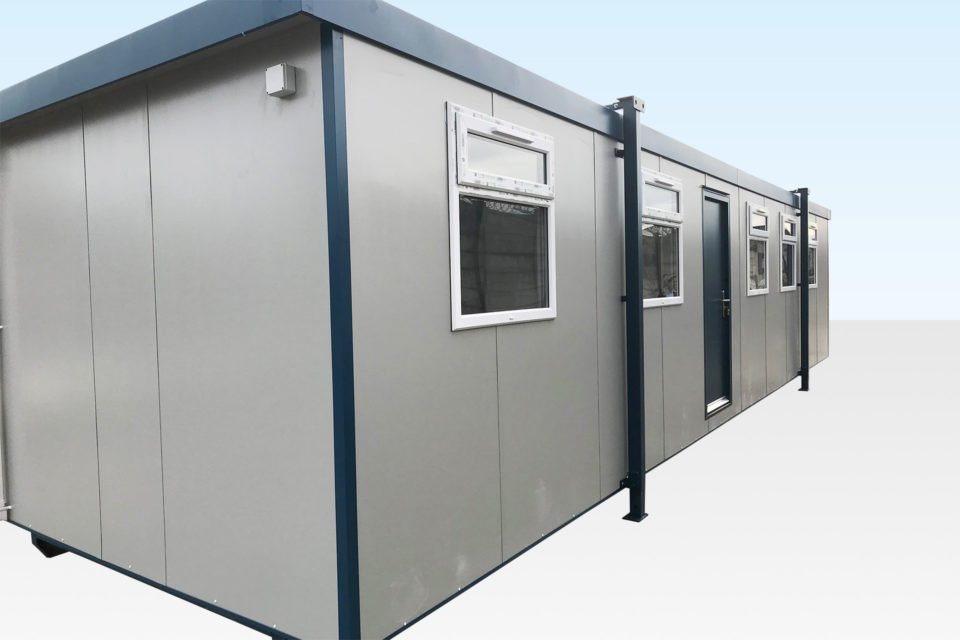 Jackleg Office Cabin – Six Double-Glazed Windows – Wide three-quarter exterior view of a large grey jackleg office cabin with windows