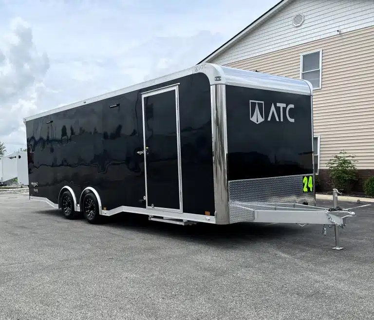 2026 ATC 24 ft Car Hauler – ROM 450, LifeTrac – Front and side view of black trailer showing entry door and hitch