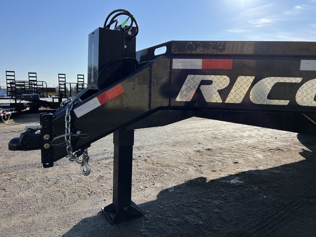 2024 Rice Trailers 18 ft Equipment Trailer – Hydraulic Jack – Close-up of the trailer hitch, safety chains, and hydraulic jack assembly