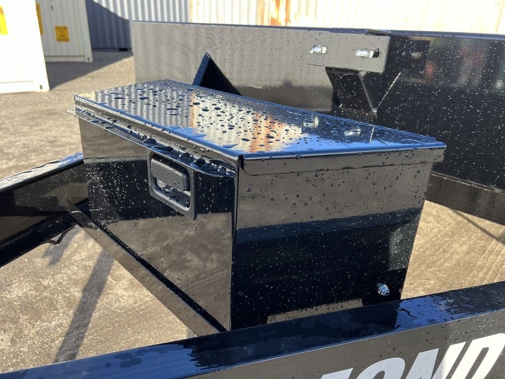 2024 Diamond C 22 ft Deckover Trailer – Slide-In Ramps – Close-up of a closed black metal toolbox mounted on the trailer frame