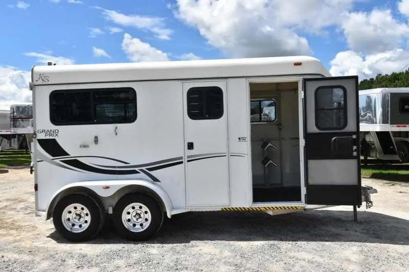 2002 Kiefer Built 2 Horse Bumper Pull – Dressing Room – Open side door showing the tack storage area with saddle racks