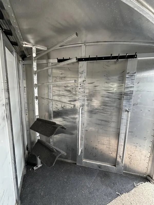 2004 Cherokee Trailers 4-Horse Gooseneck – Rear Tack – Interior view of the tack room with multiple hanging hooks and racks