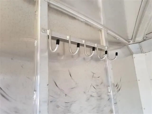 2001 4 Star 2 Horse Bumper Pull Trailer – Slant Load – A row of metal bridal hooks mounted on the wall inside the trailer