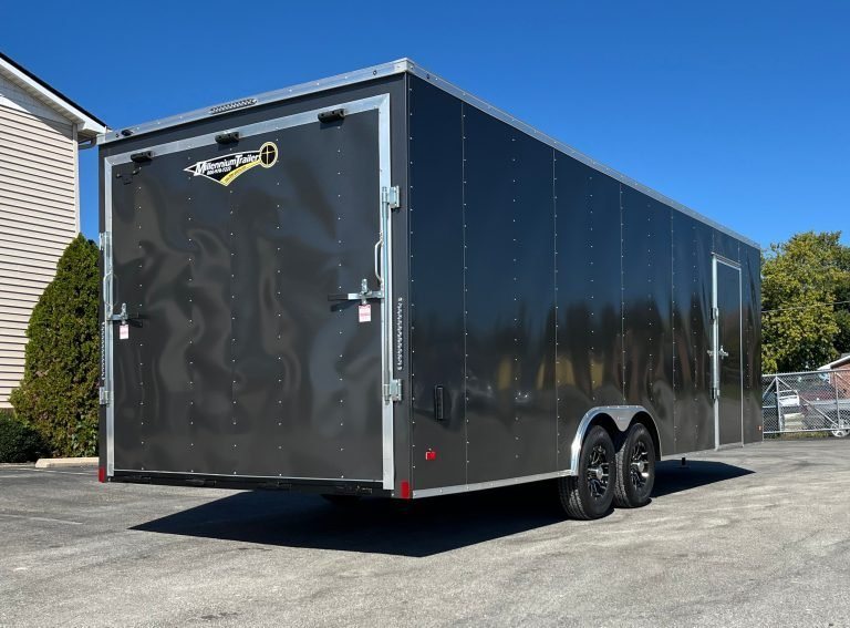 2026 Millennium 24 ft Car Hauler – Charcoal Hero – Rear view showing the closed heavy duty ramp door and side entry door