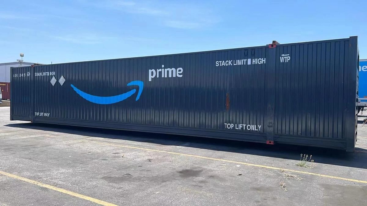 53ft High Cube Shipping Container – Used, Multi-Trip – long shipping container side view in paved storage yard