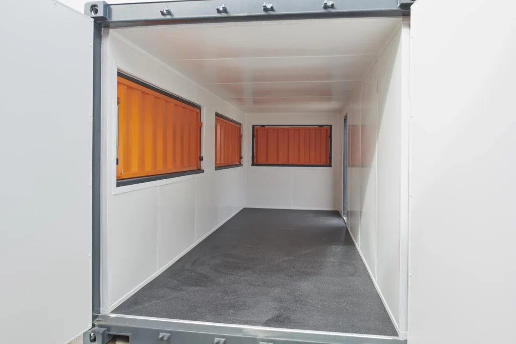 20ft Custom Container Café – Configurable Food Service Layout – empty container interior with white walls and orange service shutters