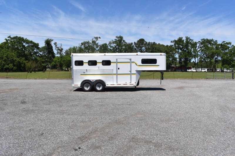2006 Adam 7302 3 Horse Trailer – Aluminum, Dressing Room – Full side profile of the white horse trailer with green and gold stripes