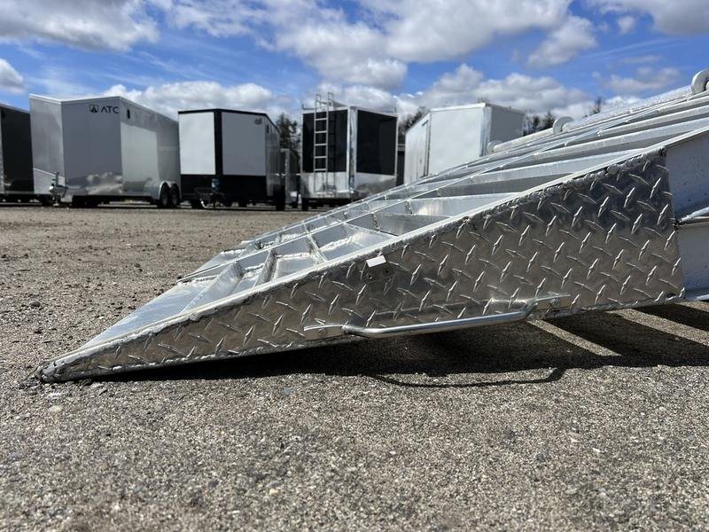 2024 Alum-Line 24 ft Gooseneck – Flip-Over Ramps – Close-up side view of the diamond plate aluminum flip-over ramp on the ground