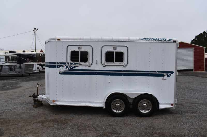 1995 Featherlite 2 Horse Trailer – Aluminum, Dressing Room – Profile shot of the white horse trailer showing double windows and teal decals