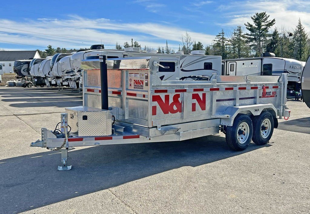 2024 N&N Trailers 14 ft Dump – Galvanized Steel – Clean three-quarter side view of a galvanized dump trailer on a paved lot