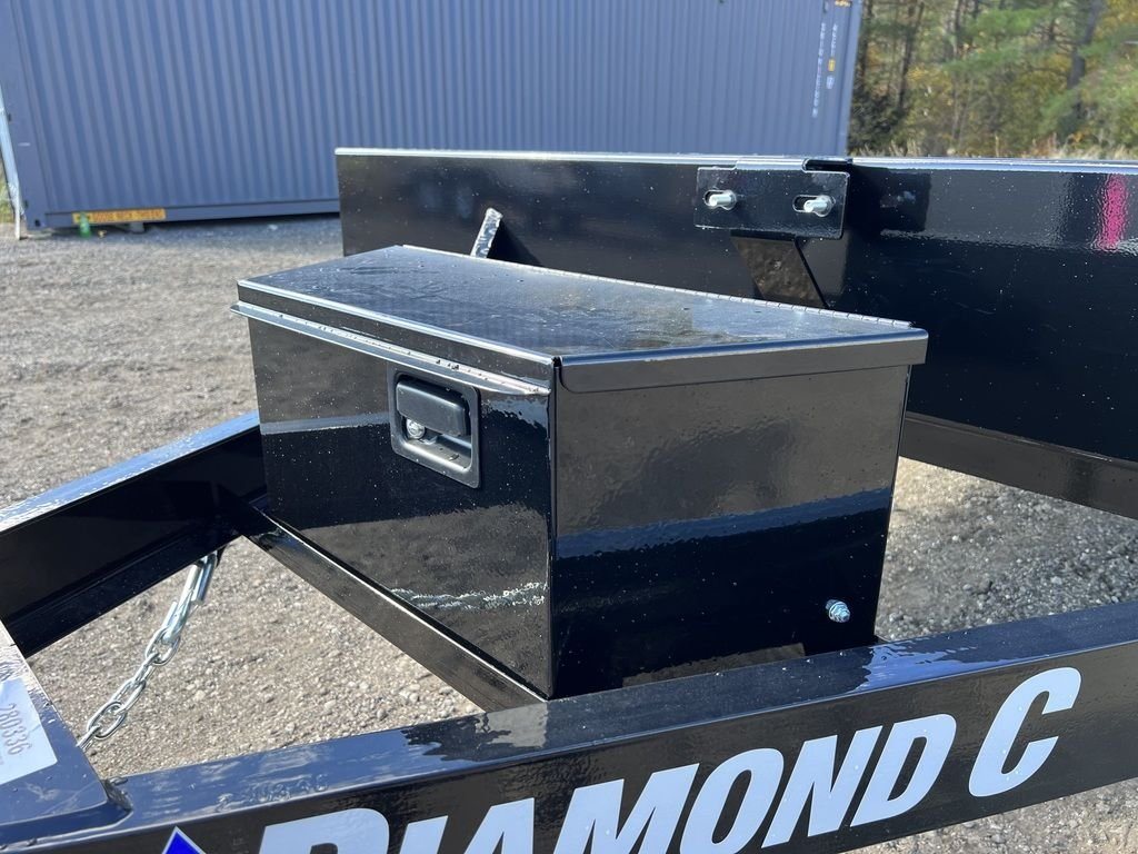 2024 Diamond C 20 ft Deckover – Slide-In Ramps – A black metal storage tool box mounted on the front of the trailer