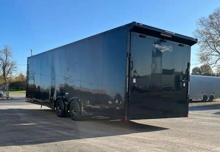 2025 Millennium 26 ft Car Hauler – Black-Out – Rear and driver side view of the black car hauler on a paved surface