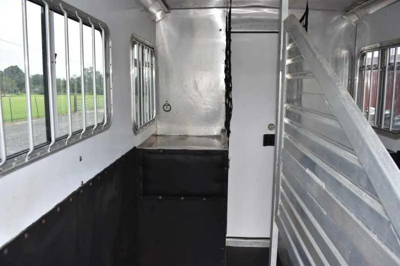 2003 Featherlite 2HST 2 Horse Trailer – Aluminum – Interior of the horse area showing padded dividers and barred windows