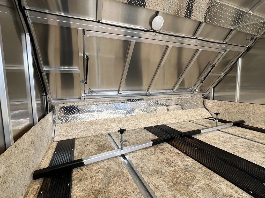 2023 Sno Pro 2-Place Snowmobile Trailer – Galvanized Package – Front interior section showing the open access hatch and tie-down bars