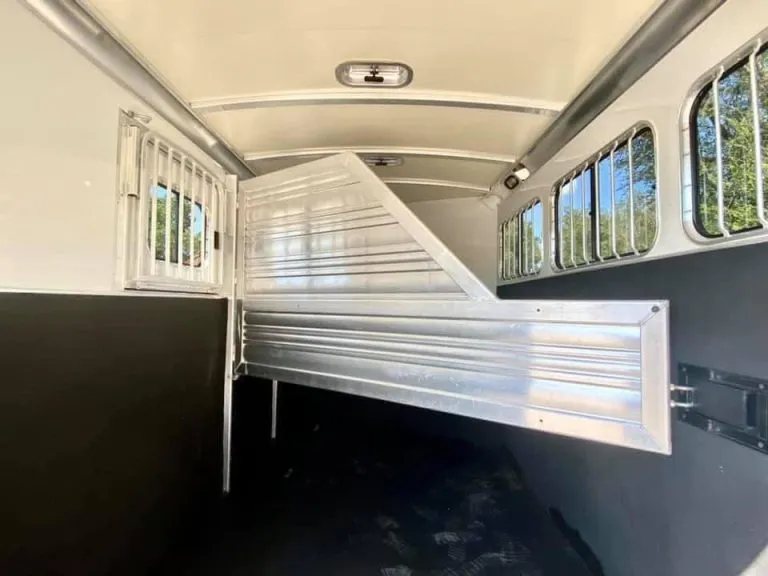 2011 Cimarron 3 Horse Bumper Pull – Insulated Roof – Interior horse compartment with padded aluminum dividers partially swung open