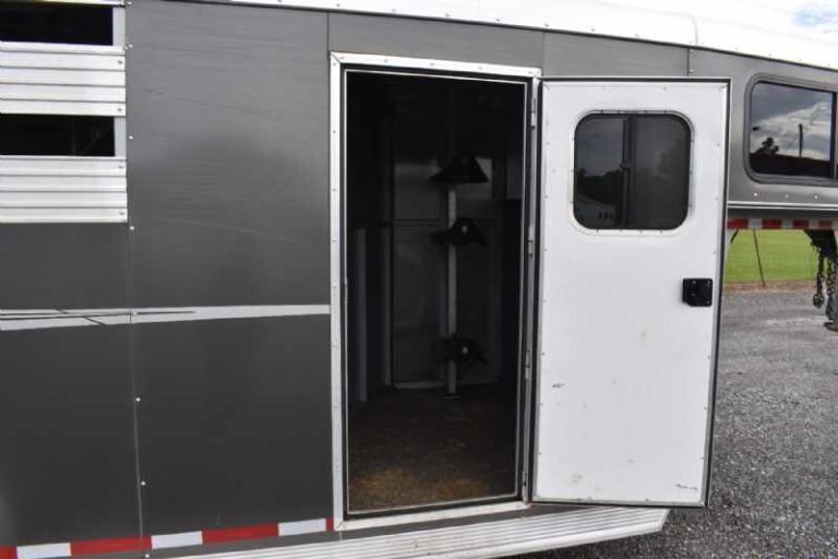 2018 Adam 3 Horse Gooseneck Trailer – Dressing Room – An open side entry door leading into the dark interior of the trailer