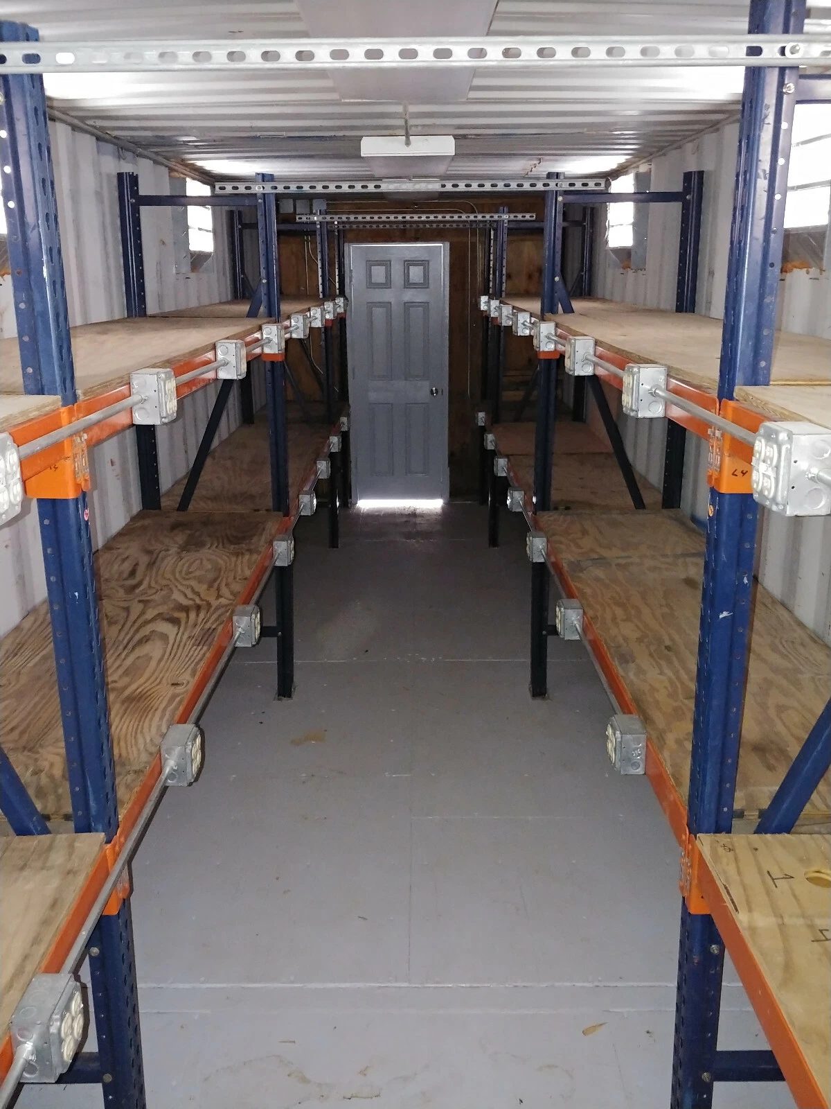40ft High Cube Container Office – Storage Racking, Side Access – container storage interior with shelving and central aisle