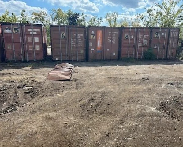 20ft Used Shipping Container – Double Cargo Doors – row of weathered shipping containers with closed cargo doors (4)