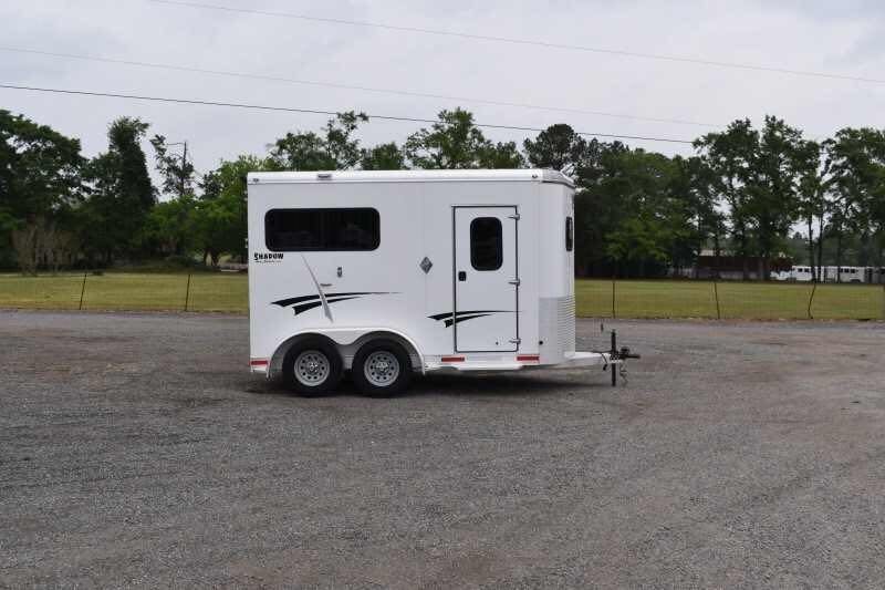 2013 Shadow 2HSL 2 Horse Trailer – Aluminum, Dressing Room – Right-side profile view of the white horse trailer showing the side door and graphics