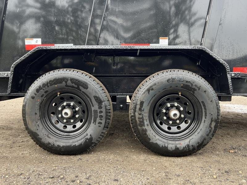 2024 RawMaxx 16 ft Dump Trailer – Tarp Kit – Close-up view of the dual axles and black wheels