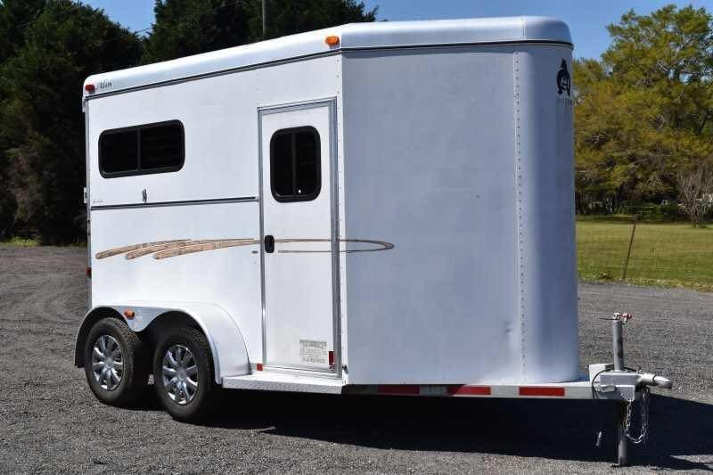 2004 Dalton 2 Horse Bumper Pull Trailer – Aluminum, Straight Load – A three-quarter exterior view of a white two-horse trailer on a gravel lot