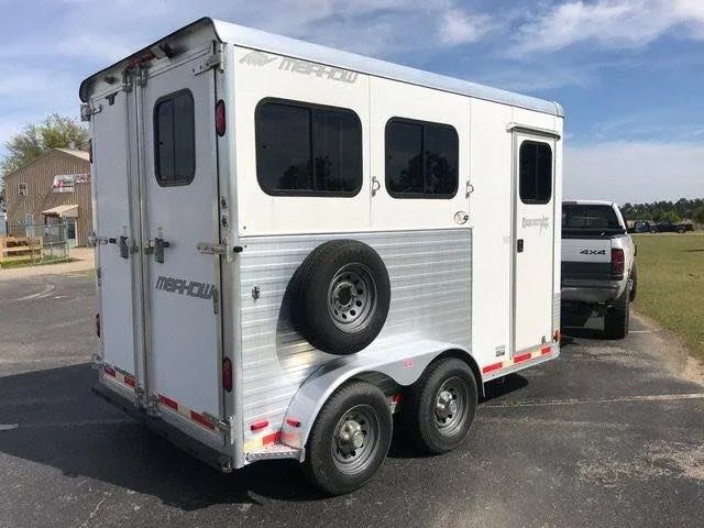 2010 Merhow 2 Horse Slant Trailer – Insulated Roof, Escape Door – Three-quarter rear exterior view showing the side with spare tire and rear doors