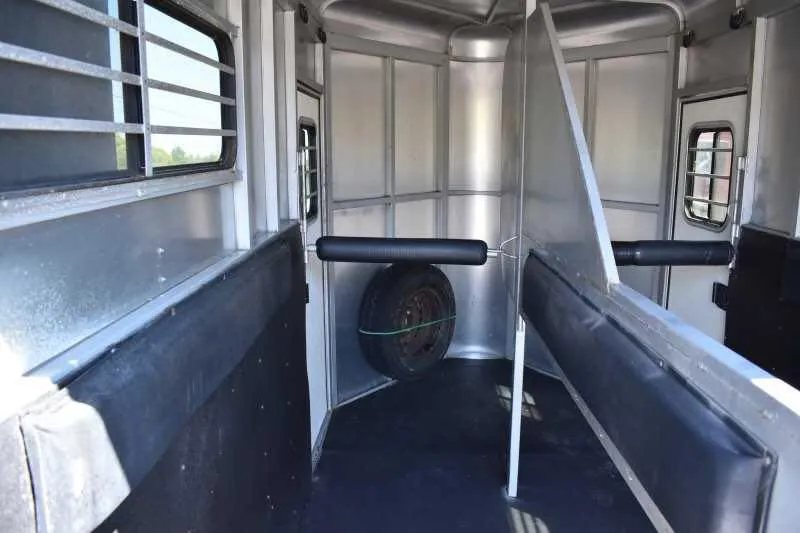 2004 Dalton 2 Horse Bumper Pull Trailer – Aluminum, Straight Load – Internal perspective of the horse stalls from the rear towards the front