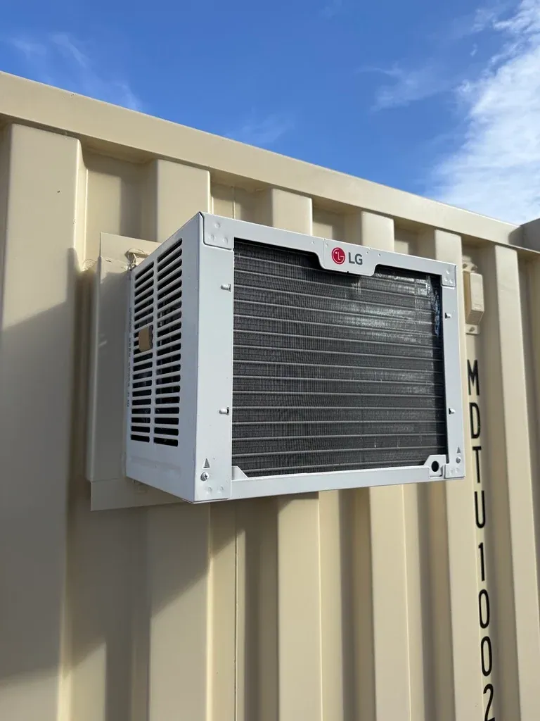 20ft Ground-Level Office Container – Insulated Workspace – air conditioner mounted on beige corrugated container wall