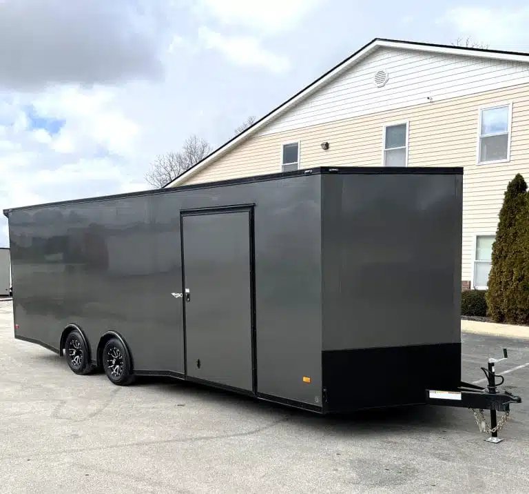 2025 Millennium 24 ft Car Hauler – Charcoal – Side profile of a grey car hauler showing the side entry door and wheels
