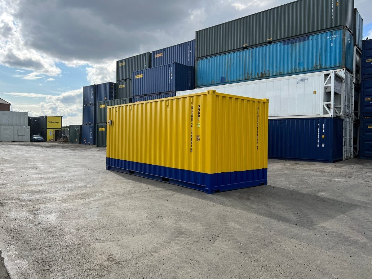 20ft One-Trip Modified Shipping Container – Electrical and LEDs – three-quarter exterior view of yellow container with blue base