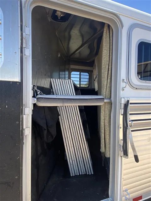 2000 Sooner 4 Horse Bumper Pull – Dressing Room, Awning – Looking through the side entry door into the storage area