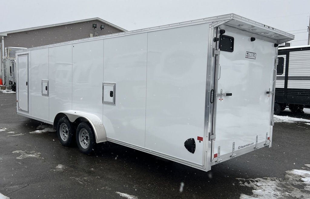 2024 E-Z Hauler 24 ft Trailer – Rear Canopy – Rear three-quarter view of a white trailer showing the rear ramp door and canopy