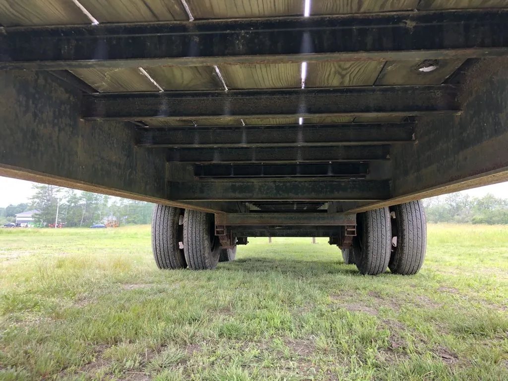 2002 Kaufman 40 ft Equipment Trailer – Toolbox – Full underside view showing both axle assemblies and the wooden floor above