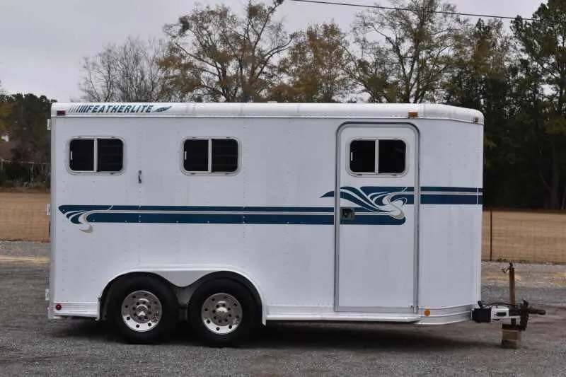 1995 Featherlite 2 Horse Trailer – Aluminum, Dressing Room – Right side profile showing the entry door and dual axles with aluminum wheels